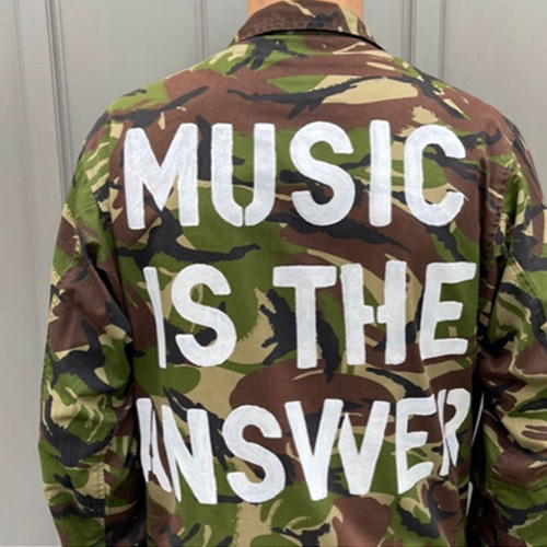 "Music Is The Answer" on a jacket.